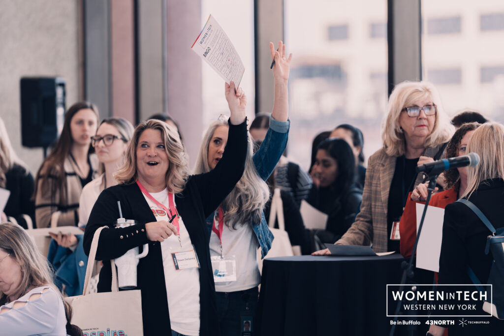 Attendees engaging in a lively Networking Bingo activity at Women in Tech WNY 2025